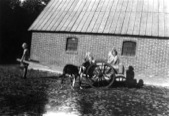 Aase, Rolf, Grete, Peder, Birgit & Inge Playing in a Cart in Gremmersteen's Farmyard